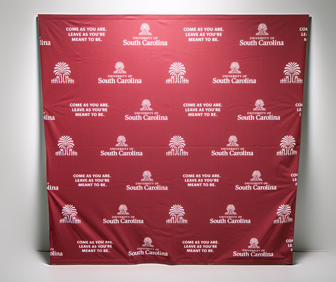 Pop up banner with the USC stamp with text spurs up and the University of South Carolina logo on a garnet background.