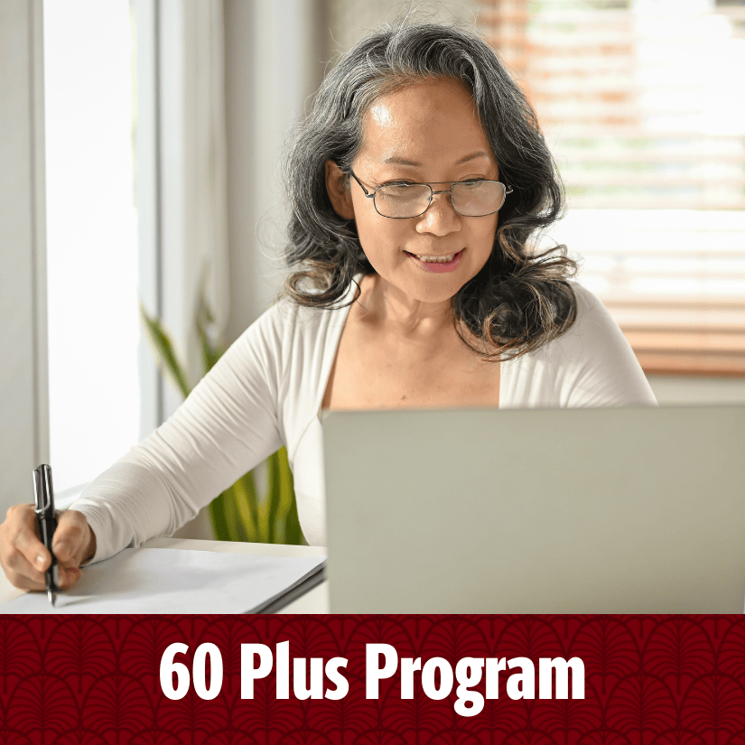 60 Plus Program (Mature female student working on laptop while taking handwritten notes)