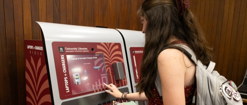 student checking out technology from kiosk