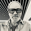 photo of a man in a beanie with dark glasses on
