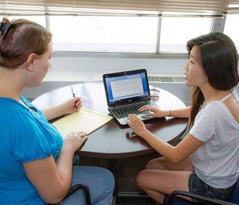Students working with a staff member