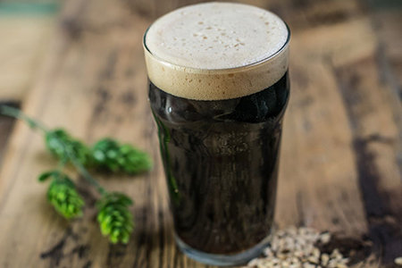 Glass of dark beer on a table