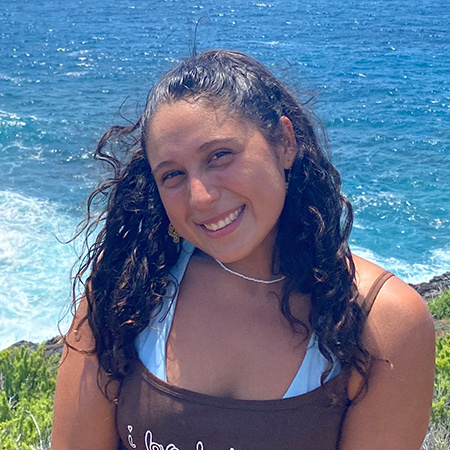 Carla Vaca Pinacho poses for a photo with a body of water in the background.