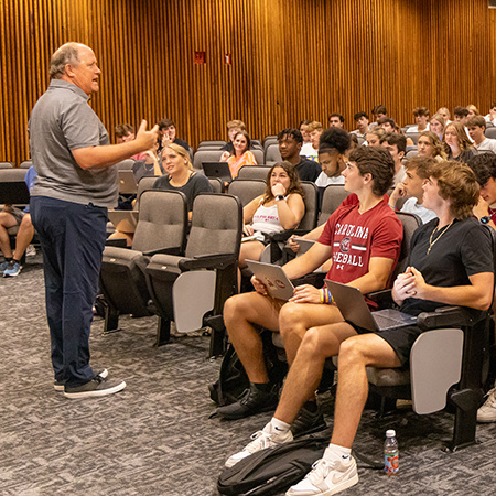 Students in a lecture hall listening to a professor