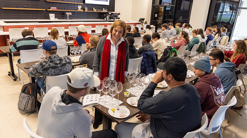 Sandy Strick speaks with students in the Beverage Lab