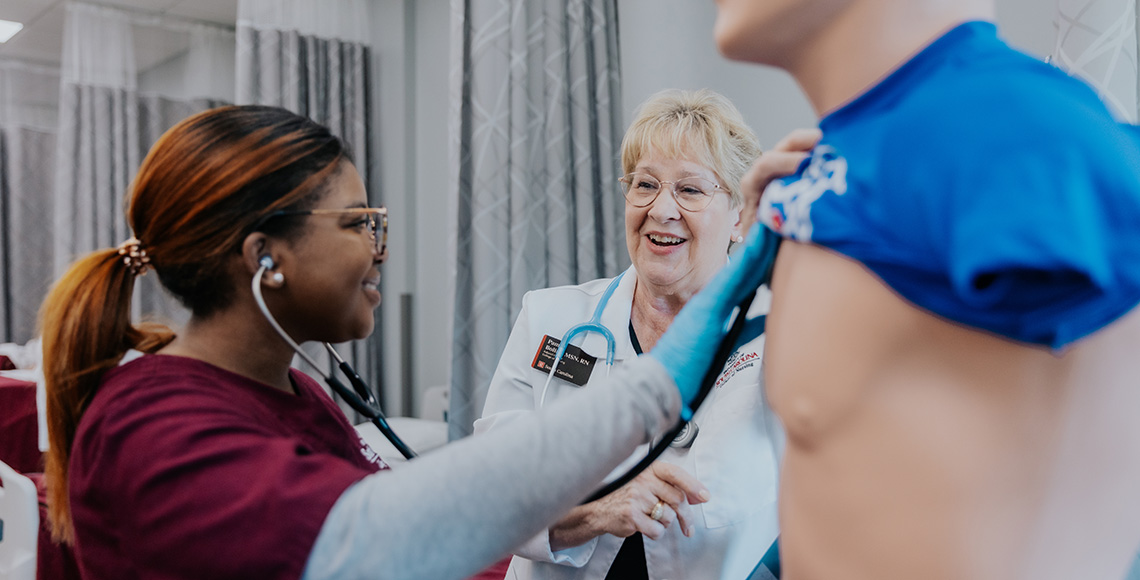 nursing student and clinical instructor in a simulation lab