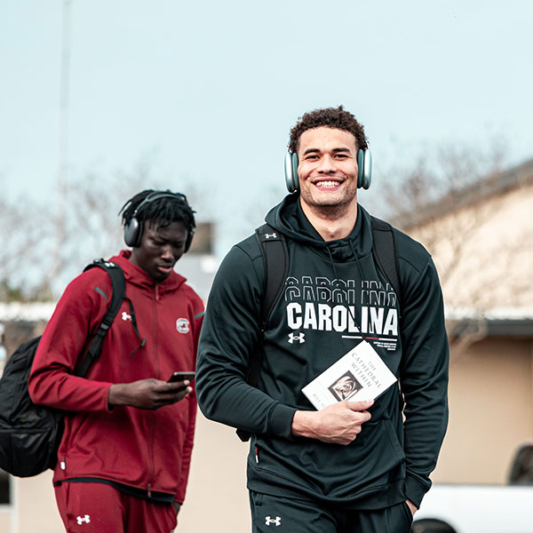 Benjamin Bosmans-Verdonk holds book as he walks