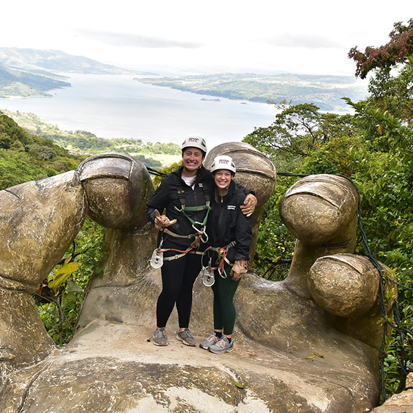 Grace Davie and another person ziplining on study away trip to Costa Rica