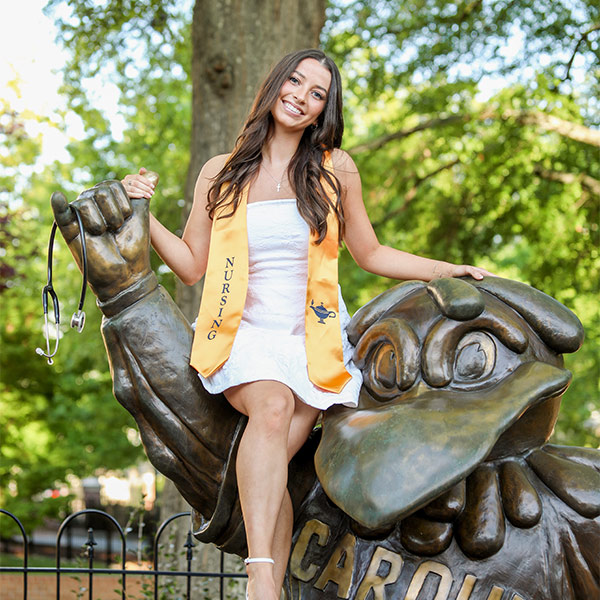 Hope Fahrner poses with the Cocky statue on campus.