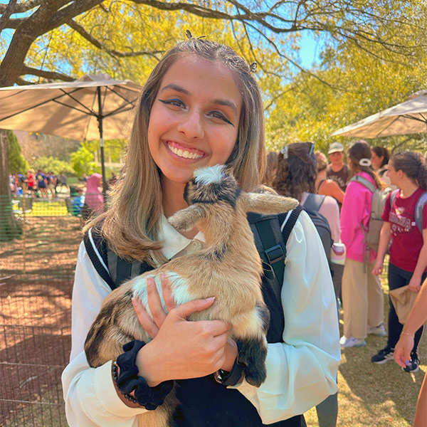 Nabeeha Baig holds a baby goat on the USC campus