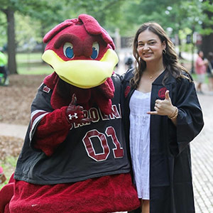 Graysann Compton stands with Cocky.