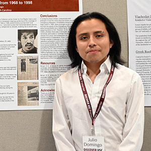Julio Domingo in front of his research poster at Discover Day on USC campus