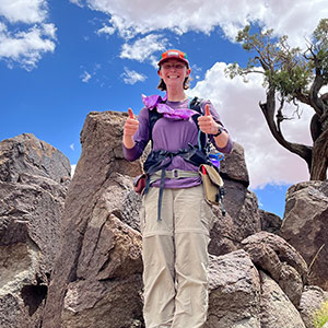 Laura Doughton stands among the rocks on a geology field trip.