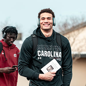 Benjamin Bosmans-Verdonk holding a book as he walks.