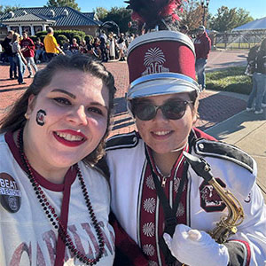 Rhaynie Bongiorno in her Carolina Band uniform, standing next to her sister.
